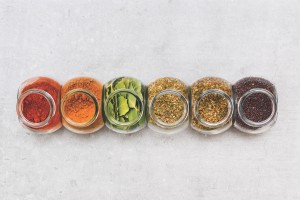 A Selection Of Herbs And Spices For Adding Flavour To Food When Cooking On A Kitchen Worktop At High Angle