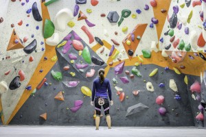 Mid Adult Caucasian Brunette Woman Looking At Indoor Artificial Climbing Wall