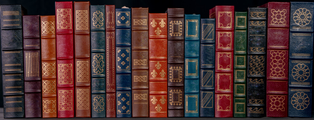 A Stack Of Leather Bound Books With Gold Decoration