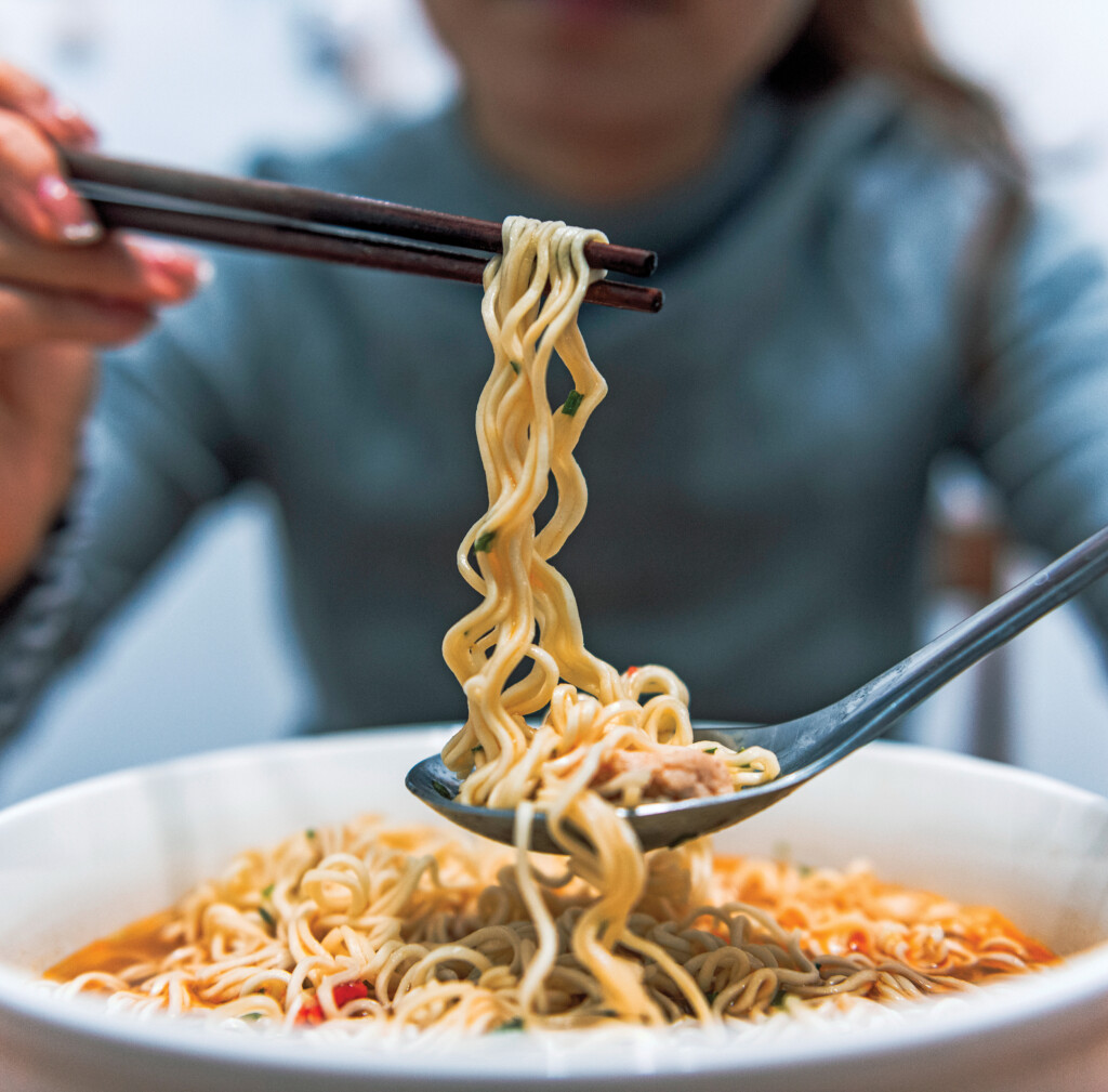 Woman Eating Instant Noodles At Home