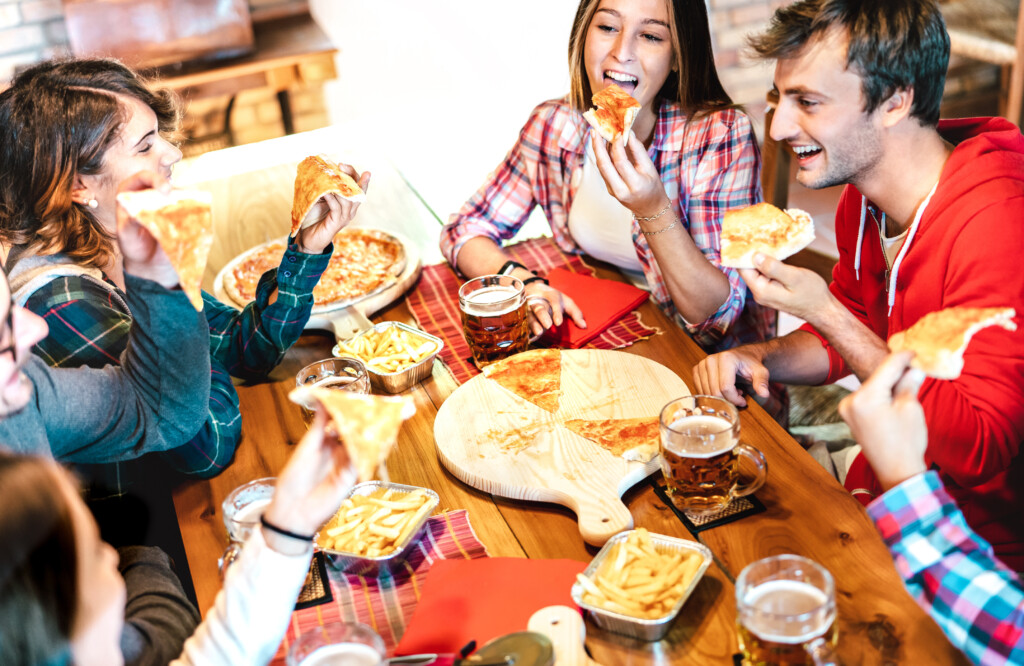 Young People On Eating Takeaway Pizza At Home On Family Reunion Friendship Life Style Concept With Happy Friends Enjoying Time Together Having Fun At Pizzeria Drinking Brew Pint Warm Bright Filter