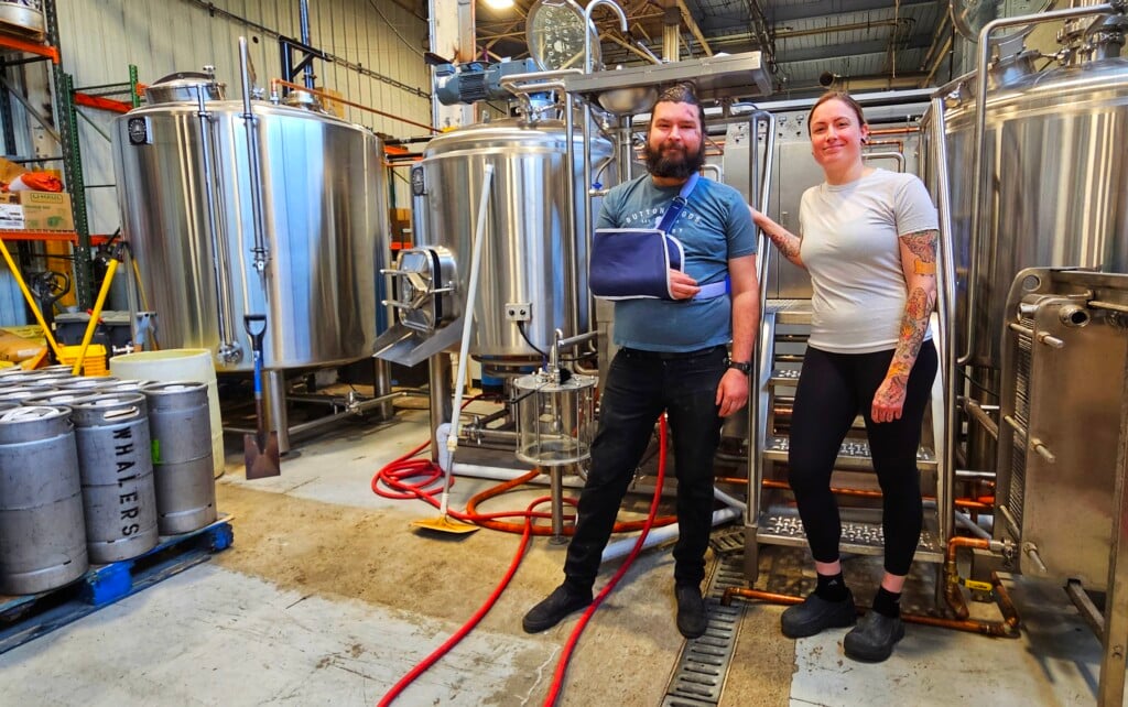 Snyder and Rapoza standing in the brewery production space.