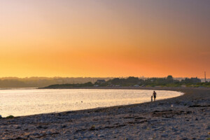 Fogland Beach, Tiverton Father And Son Enjoying A Walk On The Beach At Sunset