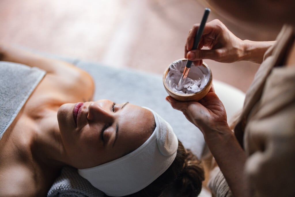 Beautiful Woman Enjoying Receiving A Facial Treatment At The Spa