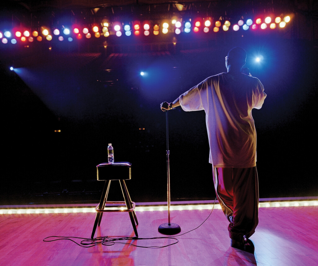 Comedian Standing On Stage, Rear View