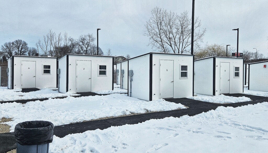Rows of white, boxy shelters in the snow with cleared walkways leading to them.