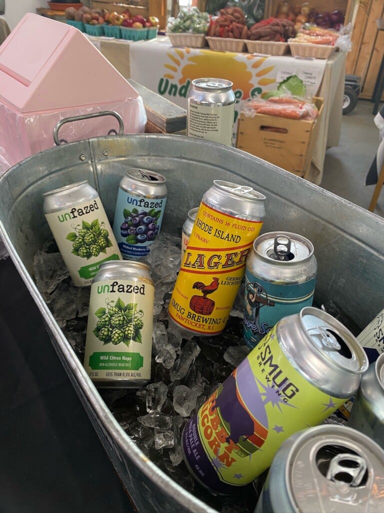 An ice bucket featuring several different styles of Smug Brewing beer, including Unfazed nonalcoholic beer.