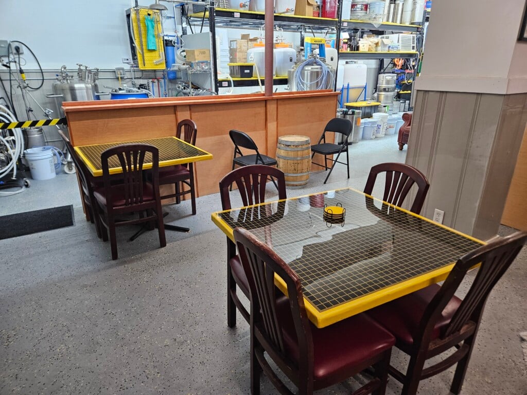 A view inside the meadery with tables and brewing equipment visible.