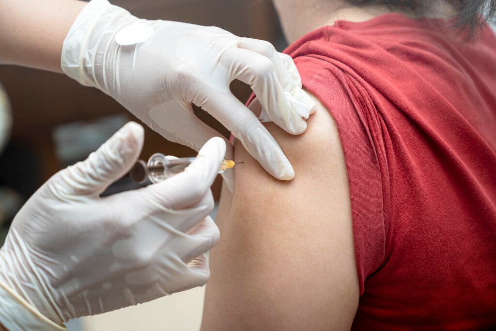 A Woman Is Getting A Shot In Her Arm