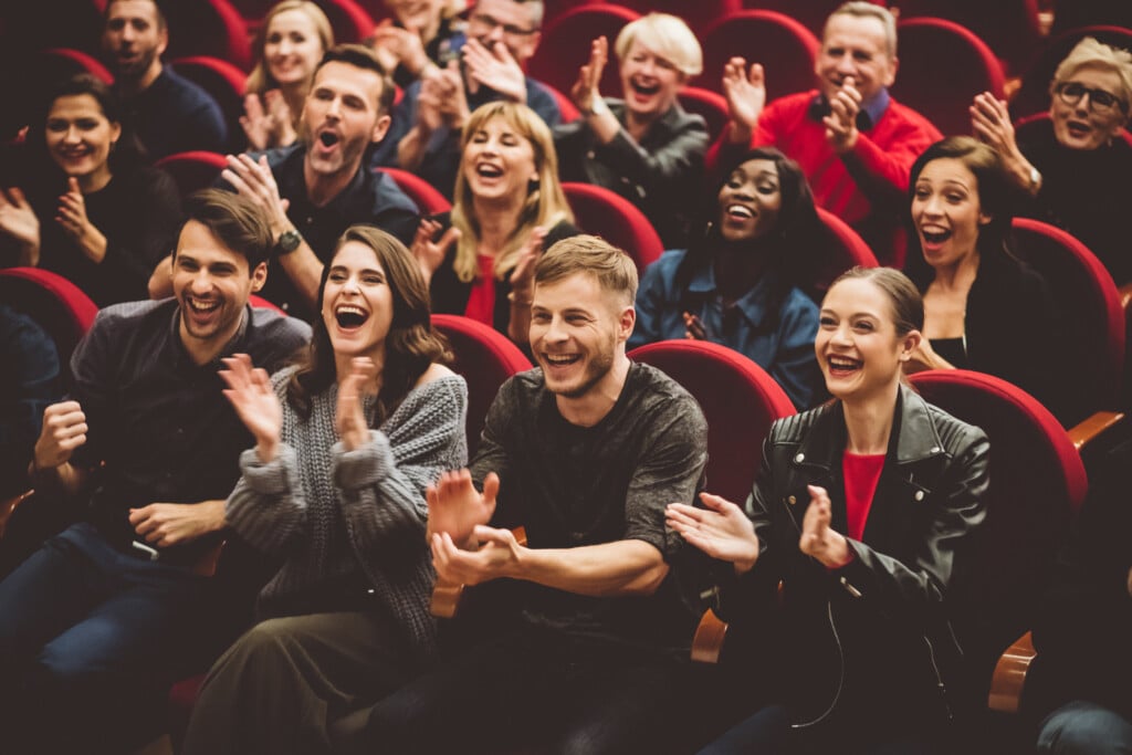 Happy Audience Applauding In The Theater