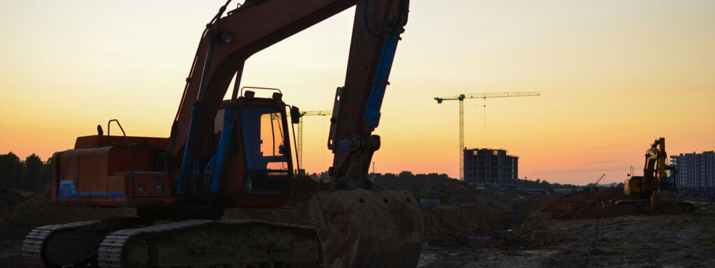 1280x480 Excavator At Construction Site On Sunset Background. 