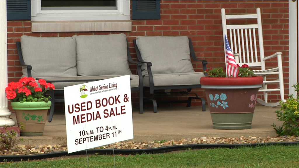 A sign promoting the Used Book and Media Sale by Abbot Senior Living. The book sale is Sept. 11 from 10 a.m. to 4 p.m.