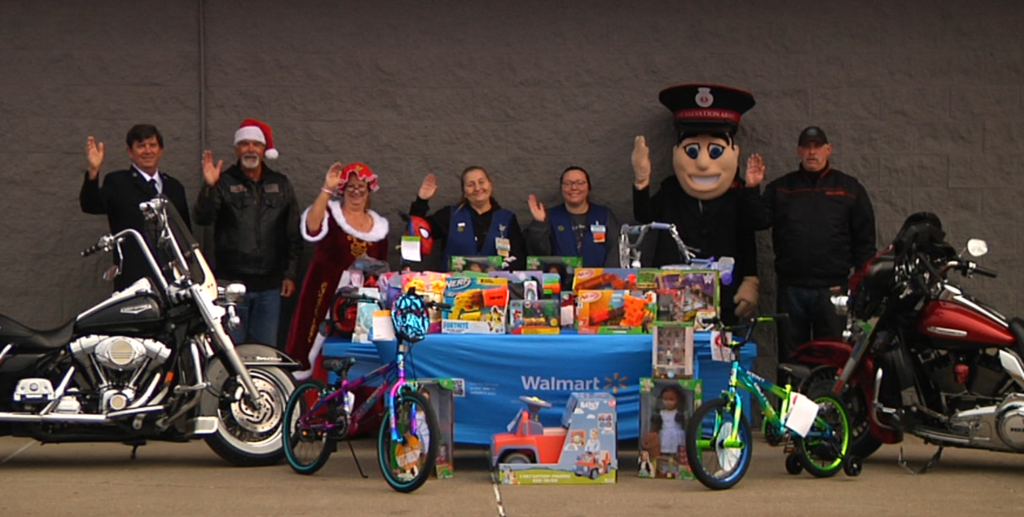 Members of the Rushing Wind Biker Church, Walmart associates, and members of the Salvation Army prepare for the Motorcyclists for Kids event on Nov. 1. Toys and monetary donations will be collects by the church for the Salvation Army to give to children of low-income homes.