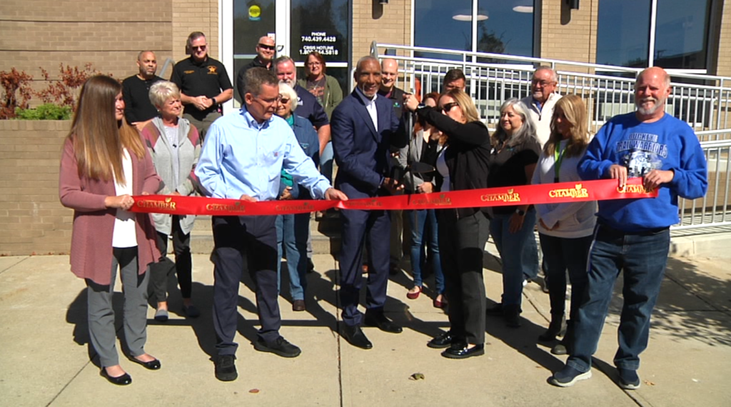James McDonald, Cambridge Mayor Tom Orr and others celebrate the opening of Allwell Behavioral Health Services' new location on Wheeling Avenue.