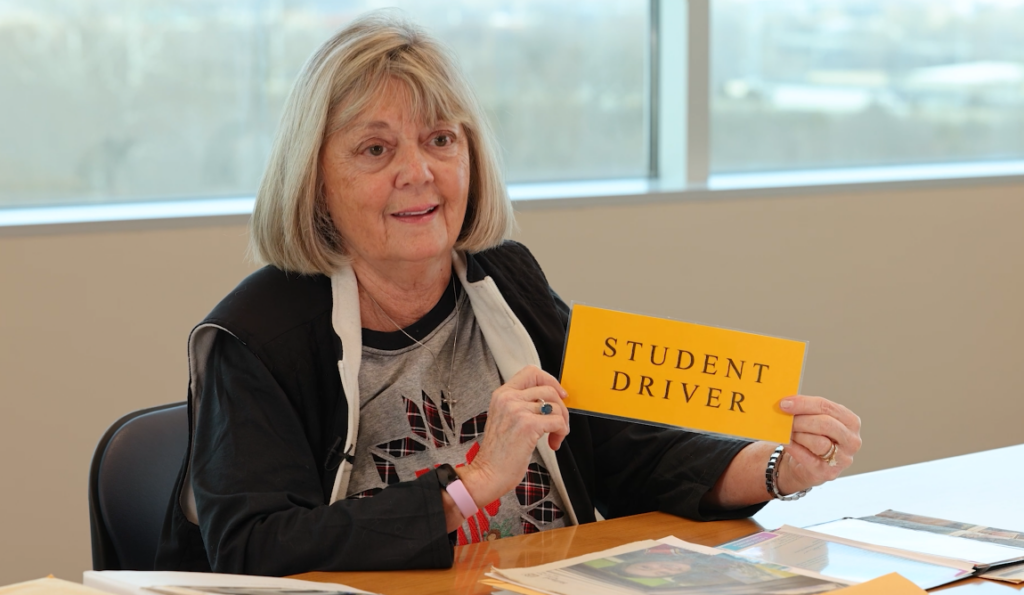 Jonna Saul-Anderson designed the original Student Driver sign while teaching her daughter to drive in 2001. Hanging the sign in car windows was illegal until 2004 when the law changed thanks to her persistence.
