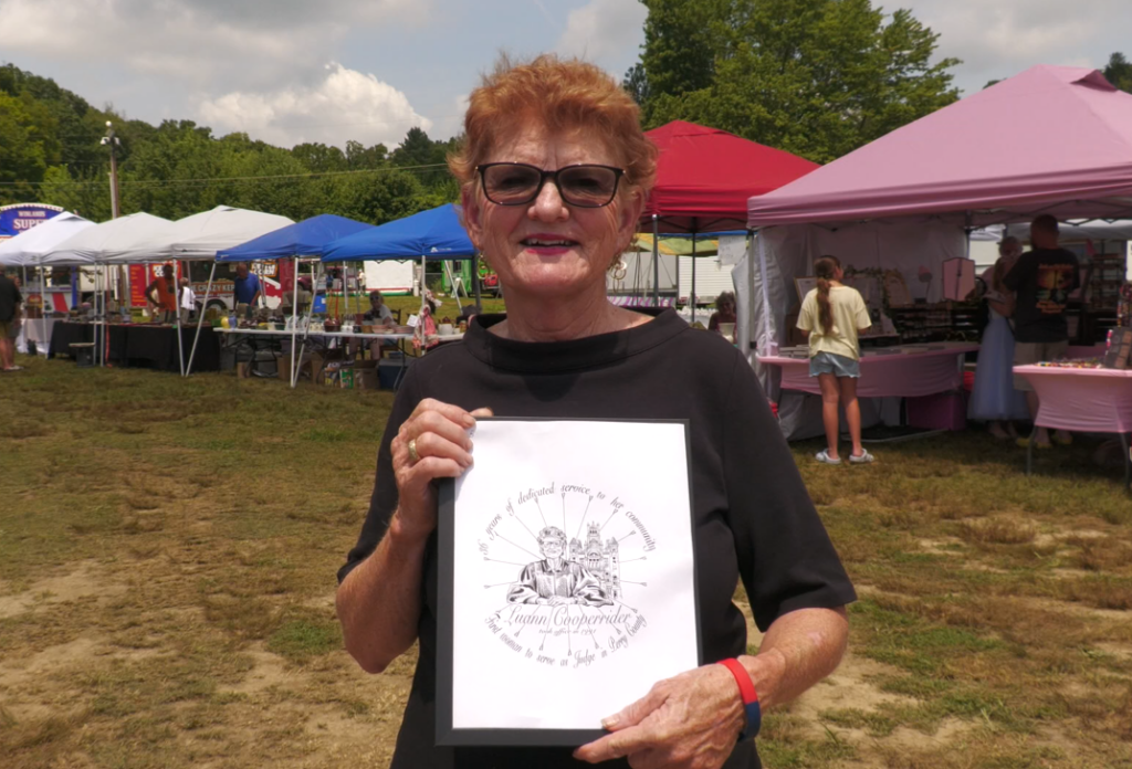 Judge Luann Cooperrider holding the design found on the Clay Center of Ohio's commemorative plate made in her honor. Cooperrider is Perry County's first female judge.