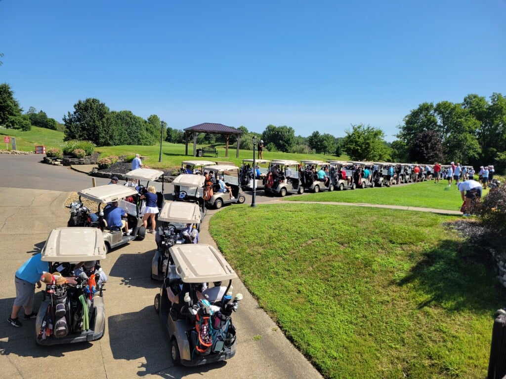 19 golf teams line up for the Eastside Community Ministry's 20th annual golf outing.
