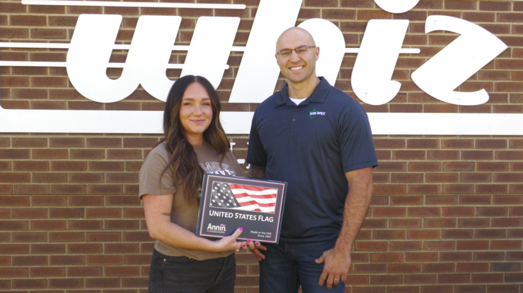 Former Navy Hospital Corpsman Nicole Schooley and Logan Wisecarver. Wisecarver presented Schooley with a flag as part of WHIZ's Military Salute.